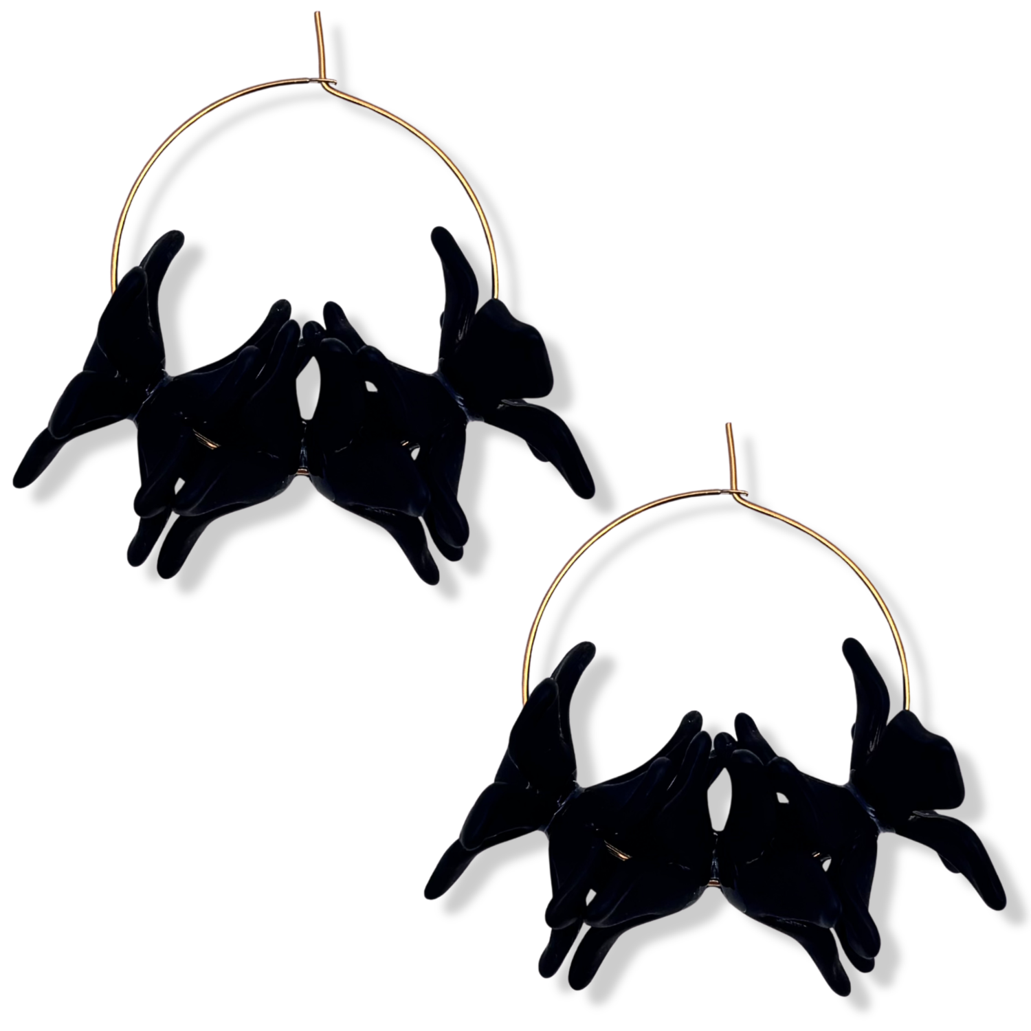 Black resin floral cluster hoop earrings with translucent black orchid-style blooms on a thin gold hoop by HOLST+LEE