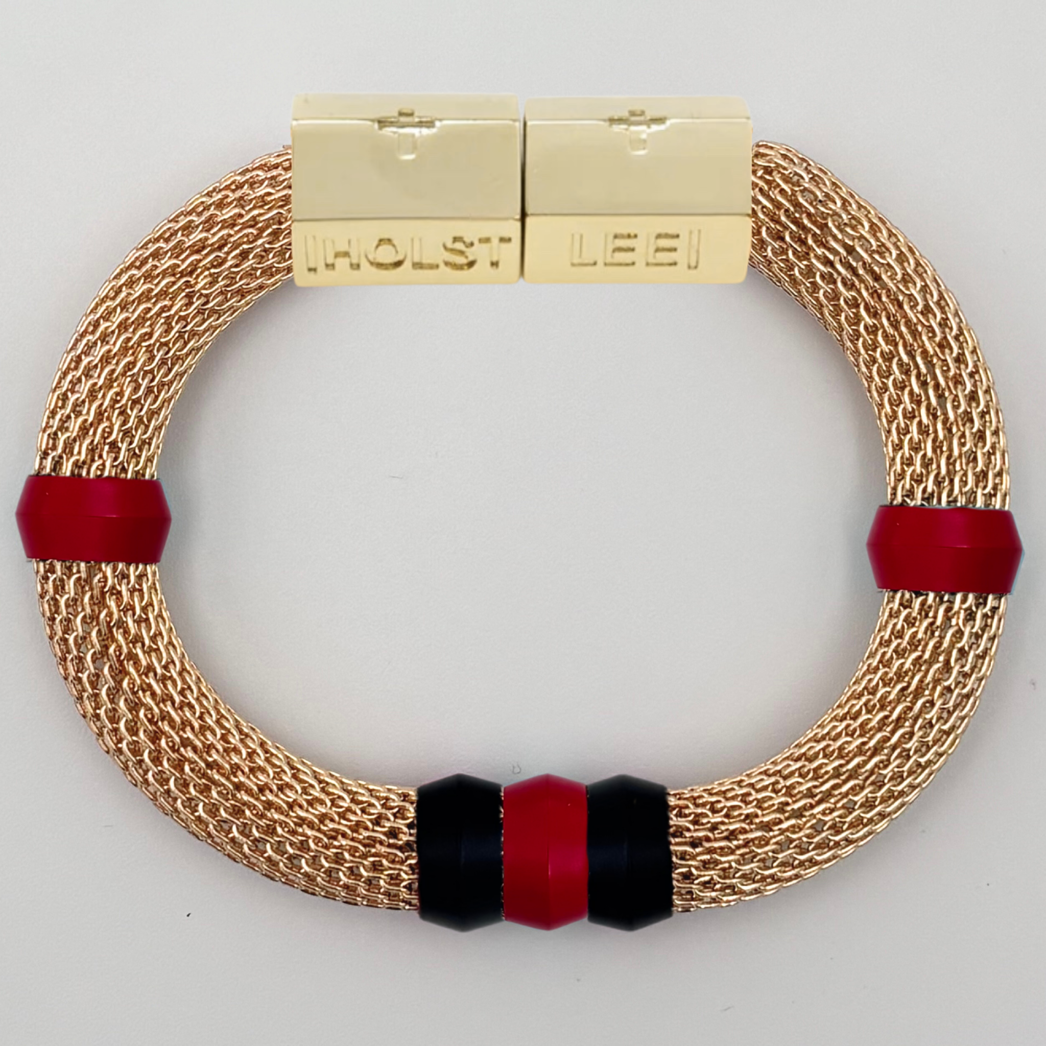 Gold woven mesh bracelet with red and black candy ferrule accents and gold magnetic clasped bracelet by HOLST+LEE