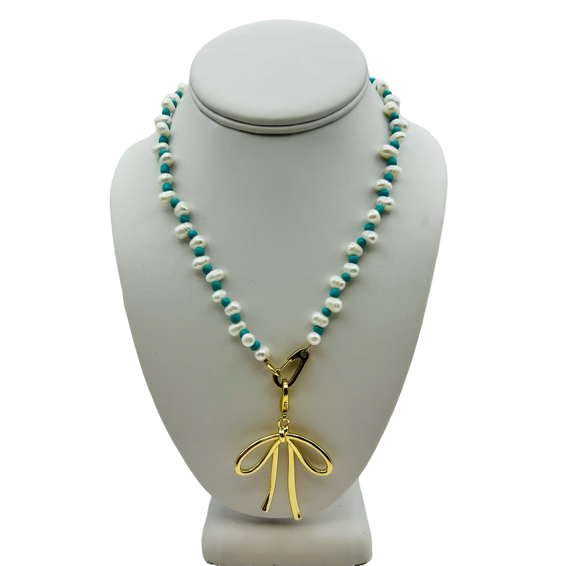 Gold Bow Charm Shown On Natural Pearl Necklace