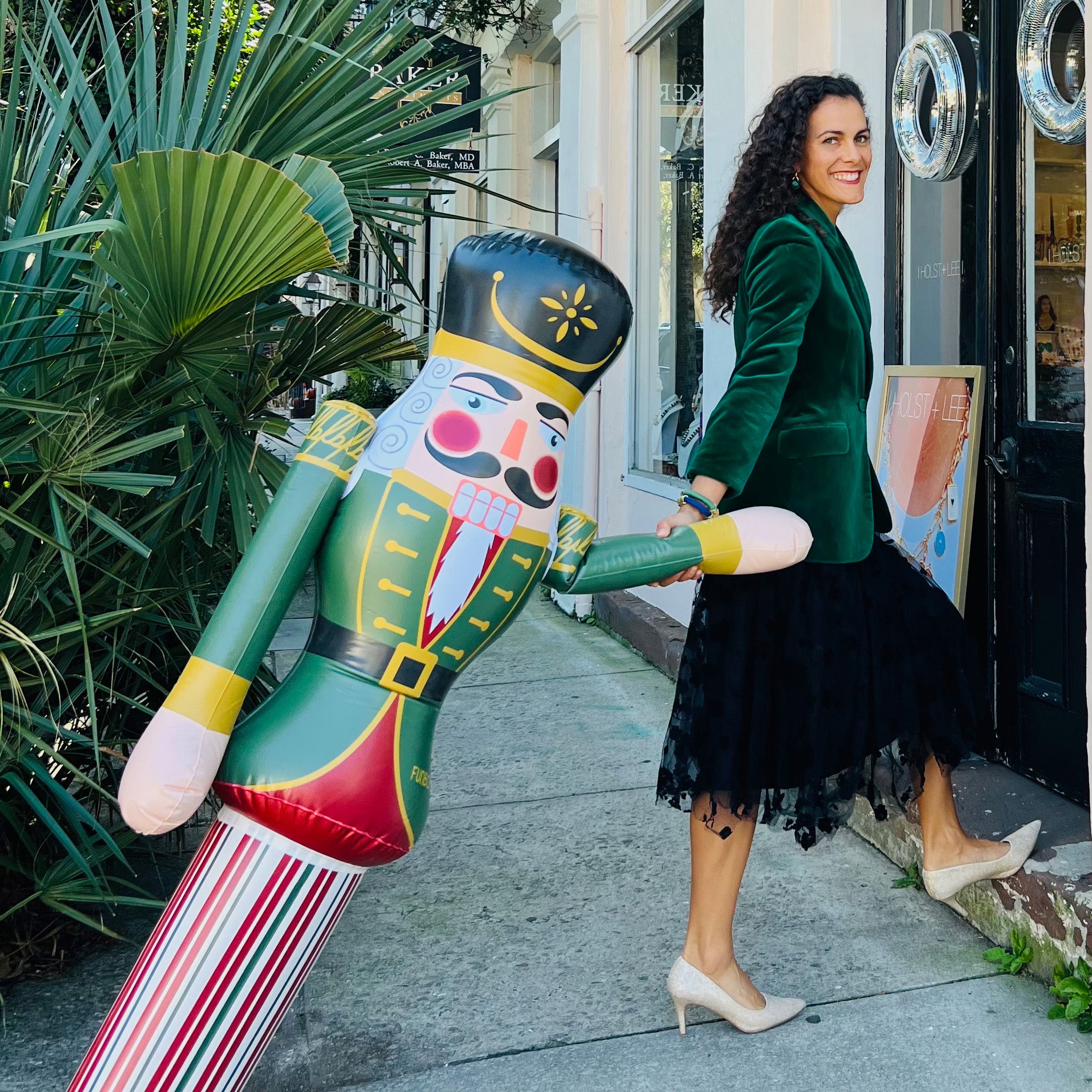 HOLST + LEE model smiling with inflatable toy soldier