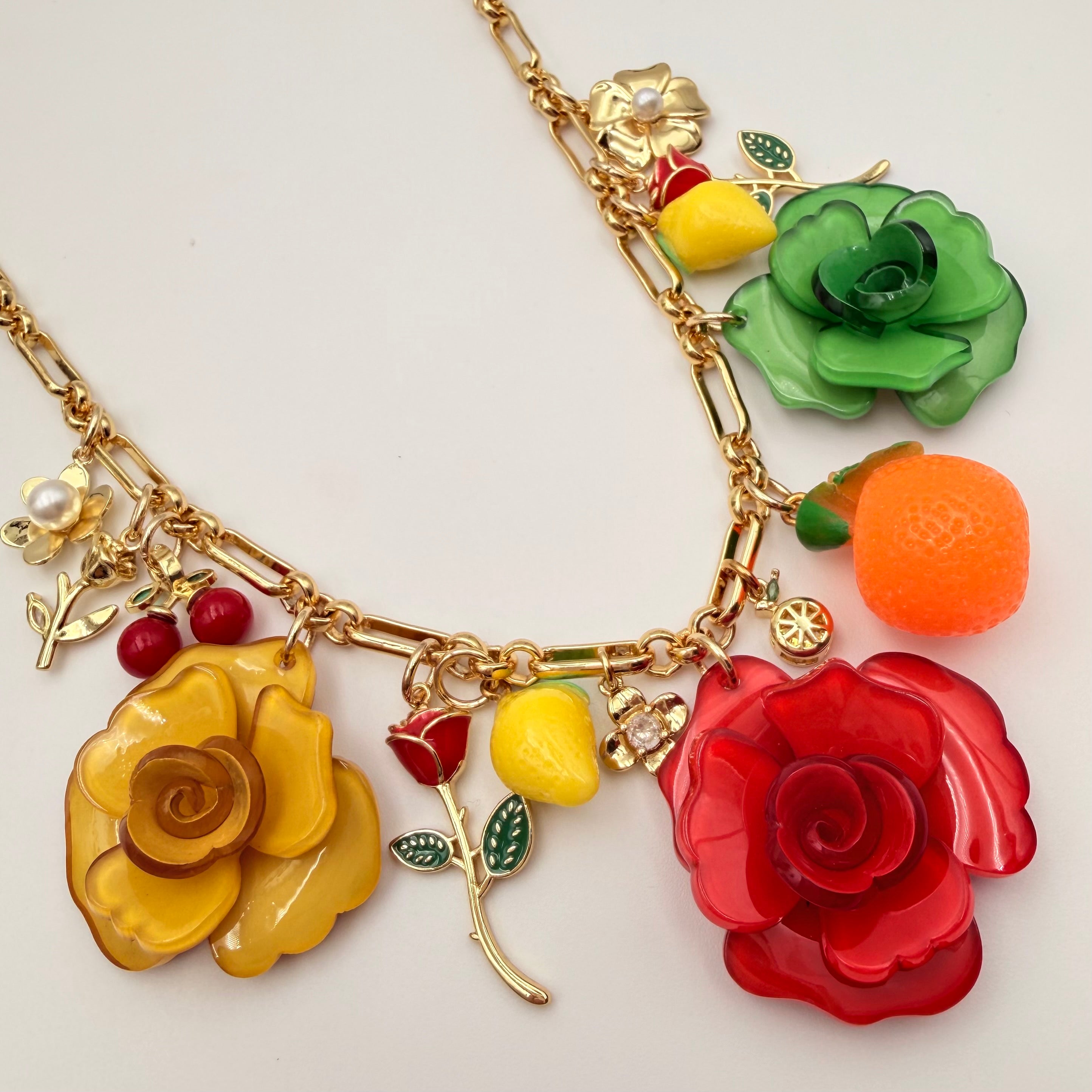 Gold link chain necklace with colorful floral and fruit enamel charms by HOLST+LEE