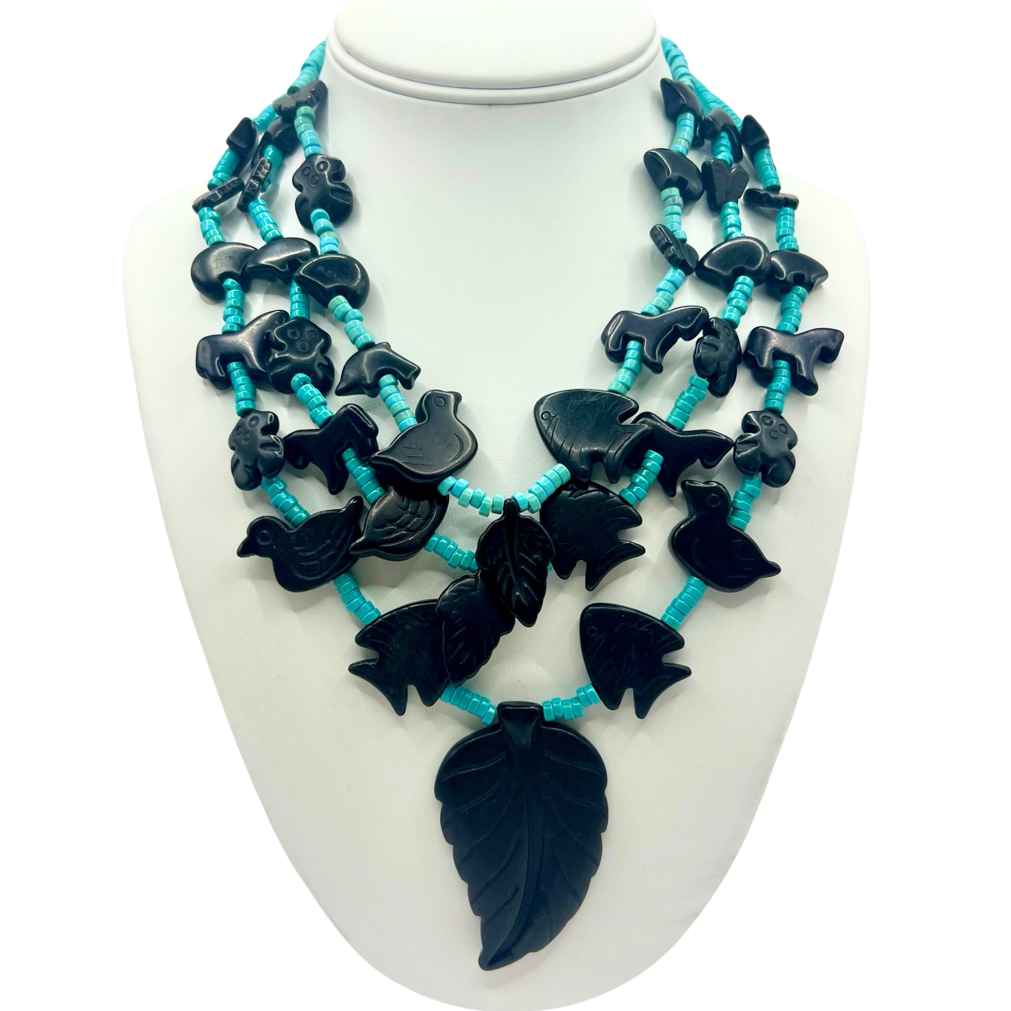 Black carved stone multi-strand necklace with turquoise heishi beads and nature-themed animal and leaf pendants by HOLST+LEE