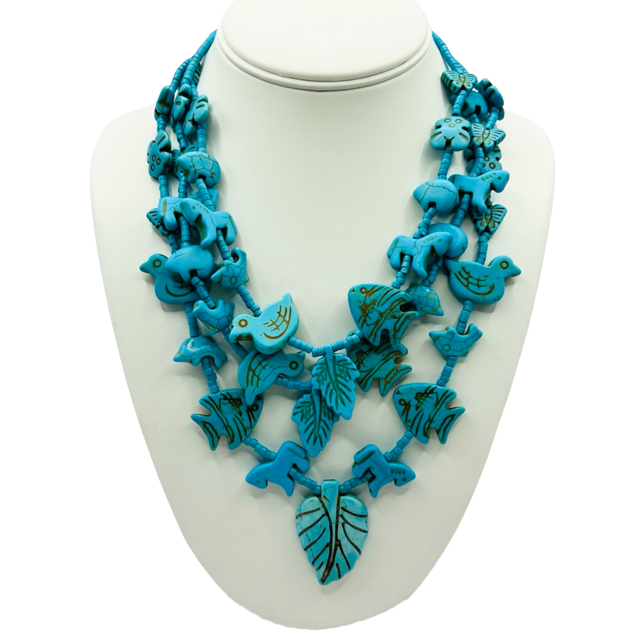 Turquoise blue carved stone multi-strand necklace with turquoise heishi beads and nature-themed animal and leaf pendants by HOLST+LEE