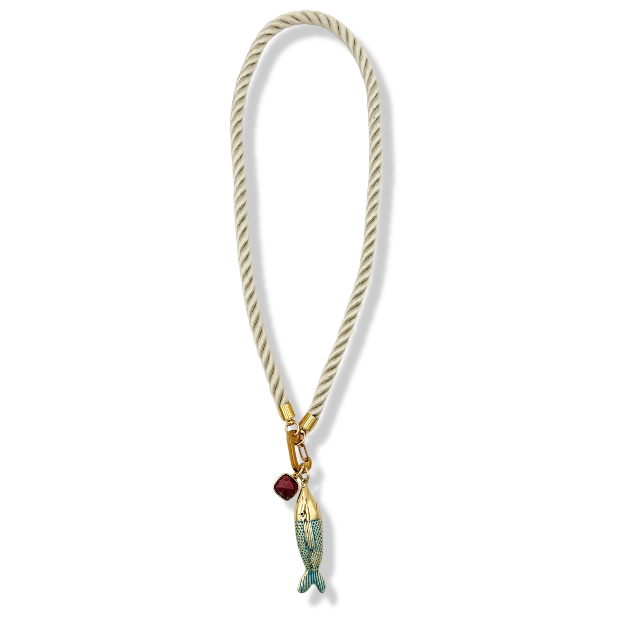 Cream twisted rope necklace with gold fish charm and dark purple stone charm by HOLST+LEE