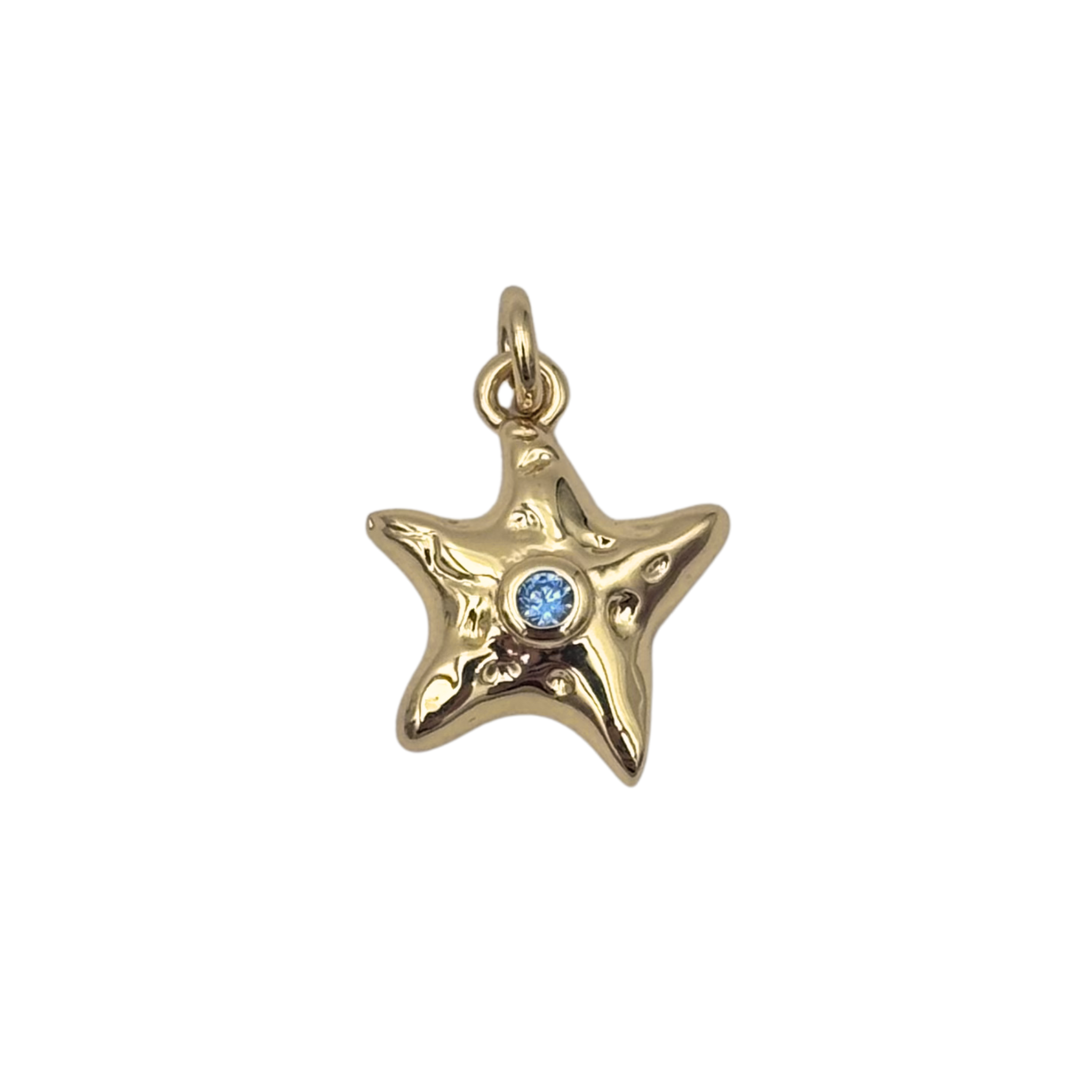 Puffy gold-tone starfish charm pendant with sculpted texture and bezel-set blue crystal center stone by HOLST+LEE