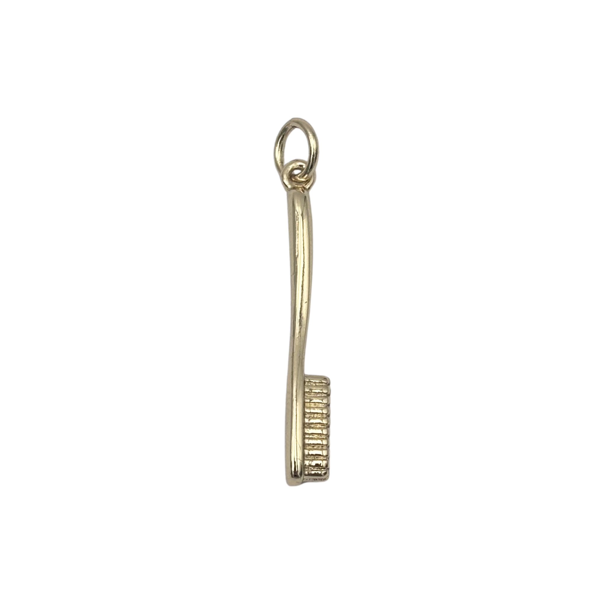 Gold toothbrush charm with curved handle and engraved bristle head by HOLST+LEE