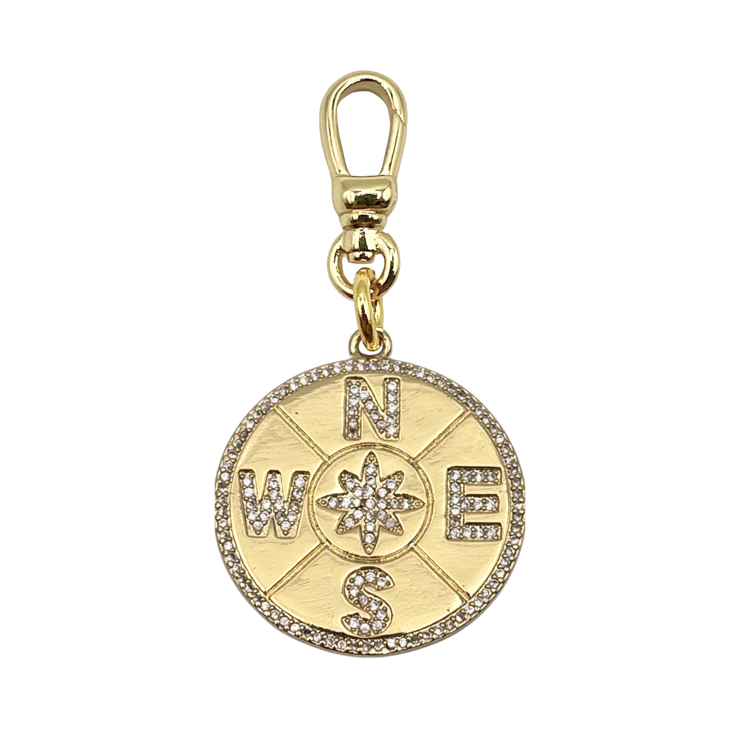 Gold compass charm with 'N', 'W', 'E', 'S' encrusted with rhinestones and a gold charm clip by HOLST+LEE