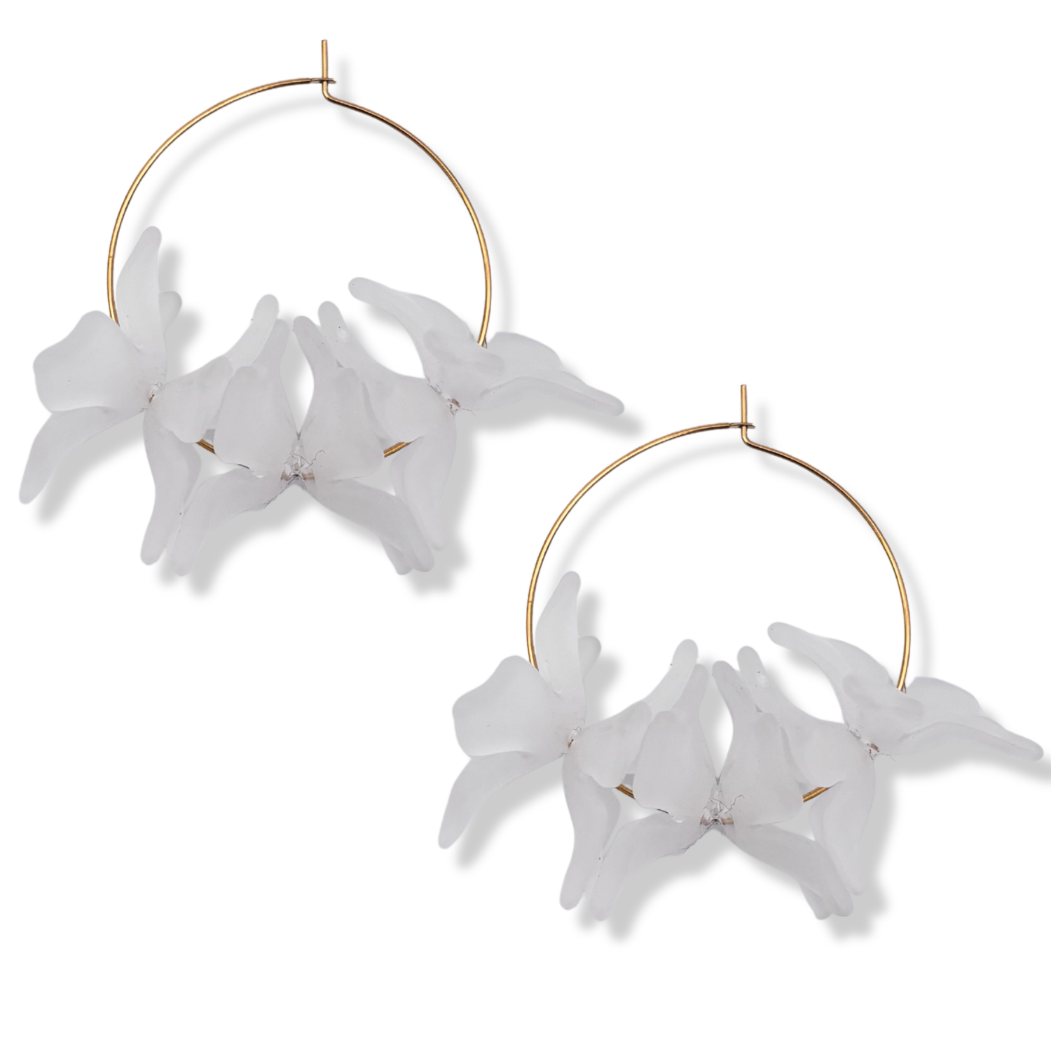White resin floral cluster hoop earrings with translucent white orchid-style blooms on a thin gold hoop by HOLST+LEE