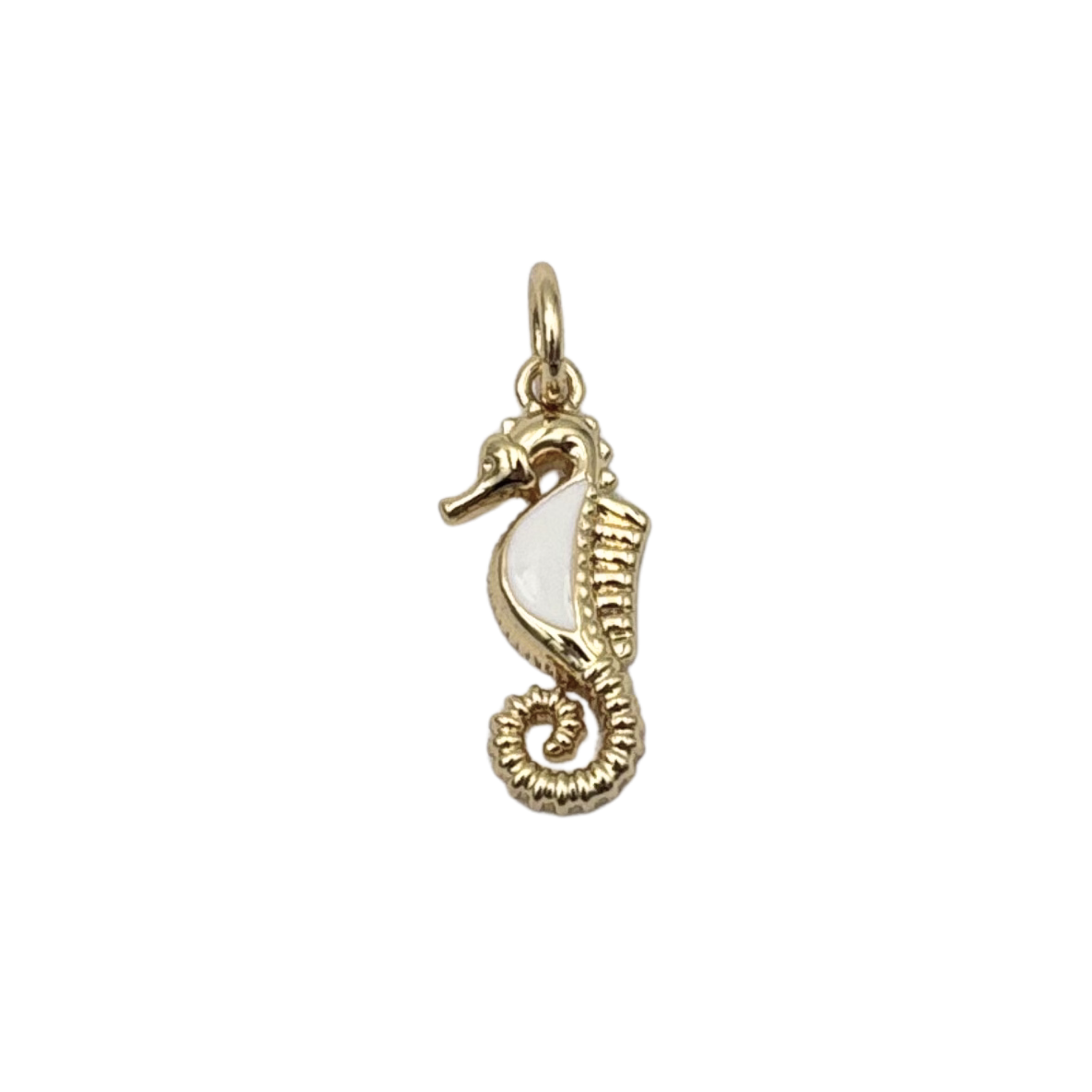 Detailed gold seahorse charm with white enamel belly, ridged texture, curled tail by HOLST+LEE