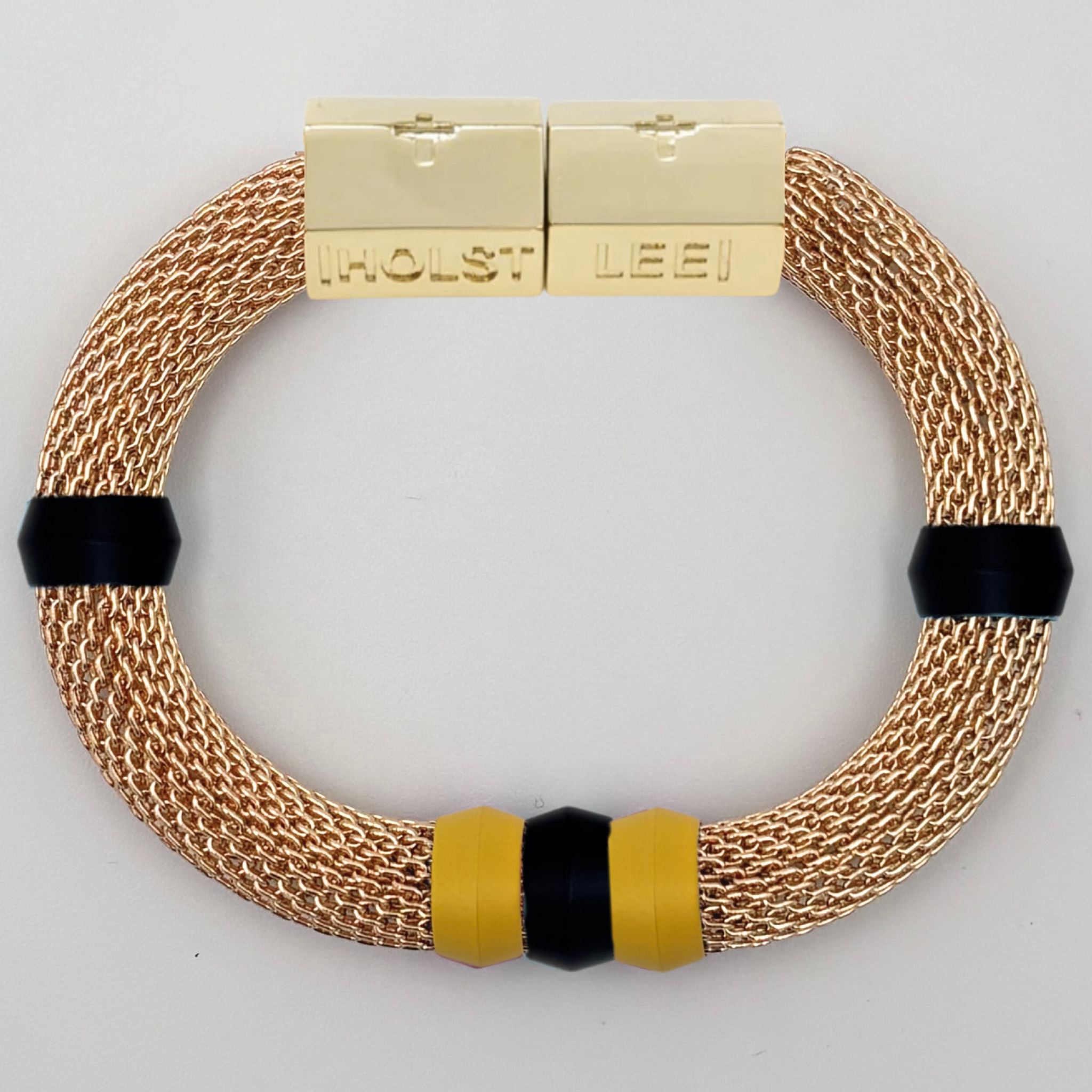 Gold woven mesh bracelet with black and yellow candy ferrule accents and gold magnetic clasped bracelet by HOLST+LEE